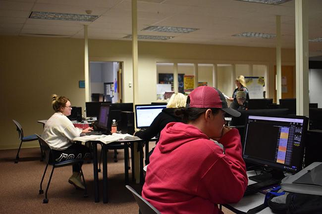 Students using the computers in a library